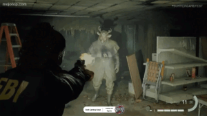 A PC gamer playing a horror survival game, with a scary scene on the monitor.